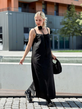 A woman wears a xiang yun silk dress